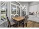 Bright breakfast nook with wood table and chairs, near a window with plantation shutters at 26803 N 45Th Pl, Cave Creek, AZ 85331