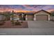 Two-car garage and front entry of this charming one-story home with desert landscaping at 26803 N 45Th Pl, Cave Creek, AZ 85331