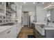 White kitchen with stainless steel appliances, patterned backsplash, and hardwood floors at 26803 N 45Th Pl, Cave Creek, AZ 85331