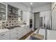 Modern kitchen with white cabinets, gas range, and patterned backsplash at 26803 N 45Th Pl, Cave Creek, AZ 85331