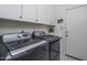 Bright laundry room with washer, dryer, and cabinets at 26803 N 45Th Pl, Cave Creek, AZ 85331