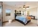 Bright bedroom with a queen bed, desk, and ample natural light at 31048 N 56Th St, Cave Creek, AZ 85331
