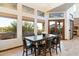 Bright dining area with large windows and a rustic wooden table at 31048 N 56Th St, Cave Creek, AZ 85331