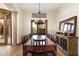 Formal dining room with a large table, chandelier, and hardwood floors at 31048 N 56Th St, Cave Creek, AZ 85331