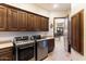 Laundry room with washer, dryer, and ample cabinet storage at 31048 N 56Th St, Cave Creek, AZ 85331