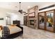 Main bedroom with stone fireplace and access to backyard patio at 31048 N 56Th St, Cave Creek, AZ 85331