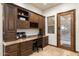 Home office features built-in wood cabinets and granite countertop at 31048 N 56Th St, Cave Creek, AZ 85331