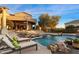 Luxury pool and spa with lounge chairs and a waterfall feature at 31048 N 56Th St, Cave Creek, AZ 85331