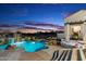 Luxury pool and spa area with waterfall feature at sunset at 31048 N 56Th St, Cave Creek, AZ 85331