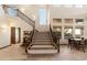 Elegant staircase with a wooden railing and carpeted steps at 31048 N 56Th St, Cave Creek, AZ 85331