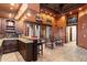 Dark wood wet bar with granite countertop and seating at 31048 N 56Th St, Cave Creek, AZ 85331