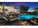 Luxury home boasts a stunning pool with rock features, a bridge, and built-in grill for ultimate outdoor entertaining at 31048 N 56Th St, Cave Creek, AZ 85331