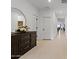 Bright entryway with wood-toned dresser and large mirror at 35208 W Santa Monica Ave, Maricopa, AZ 85138