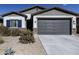 Single-story house with a two-car garage and desert landscaping at 35208 W Santa Monica Ave, Maricopa, AZ 85138