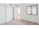 Well-lit bedroom with window and view into another room at 3609 W Royal Palm Rd, Phoenix, AZ 85051