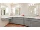 Double vanity bathroom with gray cabinets and tiled floors at 4227 W Hatcher Rd, Phoenix, AZ 85051