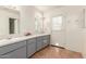 Double vanity bathroom with gray cabinets and tiled floors at 4227 W Hatcher Rd, Phoenix, AZ 85051