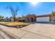 Ranch style home with a two-car garage and mature trees at 4227 W Hatcher Rd, Phoenix, AZ 85051