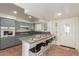 Modern kitchen with gray cabinets and breakfast bar at 4227 W Hatcher Rd, Phoenix, AZ 85051