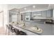 Modern kitchen with gray cabinets and breakfast bar at 4227 W Hatcher Rd, Phoenix, AZ 85051