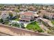 An aerial view showcases a sparkling pool, covered patio, lush landscaping, batting cage and artificial turf at 5332 E Michelle Dr, Scottsdale, AZ 85254