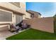 Small backyard with artificial turf and seating at 5704 E Aire Libre Ave # 1209, Scottsdale, AZ 85254