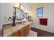 Elegant bathroom with double vanity, tile countertops, and decorative mirrors at 5827 N 129Th Ave, Litchfield Park, AZ 85340