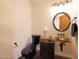 Elegant powder room with black toilet and vessel sink at 5827 N 129Th Ave, Litchfield Park, AZ 85340