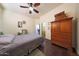 Comfortable bedroom with wood floors and dresser at 5827 N 129Th Ave, Litchfield Park, AZ 85340