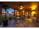 Covered patio features a dining area, heaters and lush potted plants at 5827 N 129Th Ave, Litchfield Park, AZ 85340