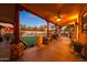 Spacious covered patio with ceiling fan, outdoor furniture, and lush landscaping at 5827 N 129Th Ave, Litchfield Park, AZ 85340