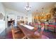 Elegant dining room features a rustic wood table and chandelier at 5827 N 129Th Ave, Litchfield Park, AZ 85340
