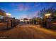 Ornate iron gate opens to a paved driveway leading to a stunning estate at 5827 N 129Th Ave, Litchfield Park, AZ 85340