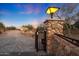 Stone pillars with gate and driveway leading to a beautiful house at 5827 N 129Th Ave, Litchfield Park, AZ 85340