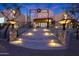 Elegant entryway with staircase, stonework, wrought iron railings, and lighting at 5827 N 129Th Ave, Litchfield Park, AZ 85340