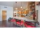 Kitchen island with seating, granite countertops, and pendant lighting at 5827 N 129Th Ave, Litchfield Park, AZ 85340