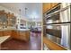 Spacious kitchen featuring granite countertops, stainless steel appliances, and custom wood cabinetry at 5827 N 129Th Ave, Litchfield Park, AZ 85340