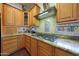 Bright kitchen boasts granite countertops, gas cooktop, and ample wood cabinetry at 5827 N 129Th Ave, Litchfield Park, AZ 85340