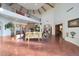 Open living area featuring high ceilings, a fireplace and hardwood floors at 5827 N 129Th Ave, Litchfield Park, AZ 85340
