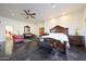 Large main bedroom with sitting area, ceiling fan, and ensuite bathroom at 5827 N 129Th Ave, Litchfield Park, AZ 85340