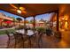 Outdoor dining area on the covered patio with glass-top table and wrought iron chairs at 5827 N 129Th Ave, Litchfield Park, AZ 85340