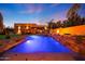 Stunning pool with a waterfall and fire feature at sunset at 5827 N 129Th Ave, Litchfield Park, AZ 85340