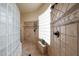 Walk-in shower with tile surround and glass block accents at 5827 N 129Th Ave, Litchfield Park, AZ 85340