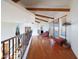 Upstairs hallway with hardwood floors and access to balcony at 5827 N 129Th Ave, Litchfield Park, AZ 85340