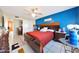 Main bedroom with a king-size bed, dark wood furniture, and an accent wall at 7132 W Vermont Ave, Glendale, AZ 85303