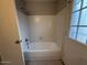 Clean bathroom with bathtub and window at 8520 W Palm Ln # 1021, Phoenix, AZ 85037