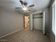 Bedroom with tile floors, ceiling fan, and spacious closet at 8520 W Palm Ln # 1021, Phoenix, AZ 85037