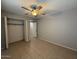 Spacious bedroom with tile floors, ceiling fan and closet at 8520 W Palm Ln # 1021, Phoenix, AZ 85037