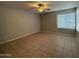 Bright bedroom with tile floor and window blinds at 8520 W Palm Ln # 1021, Phoenix, AZ 85037