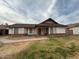 Single story home with brick facade and grassy front yard at 8520 W Palm Ln # 1021, Phoenix, AZ 85037